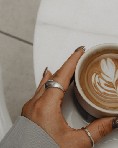 woman touching cup of coffee