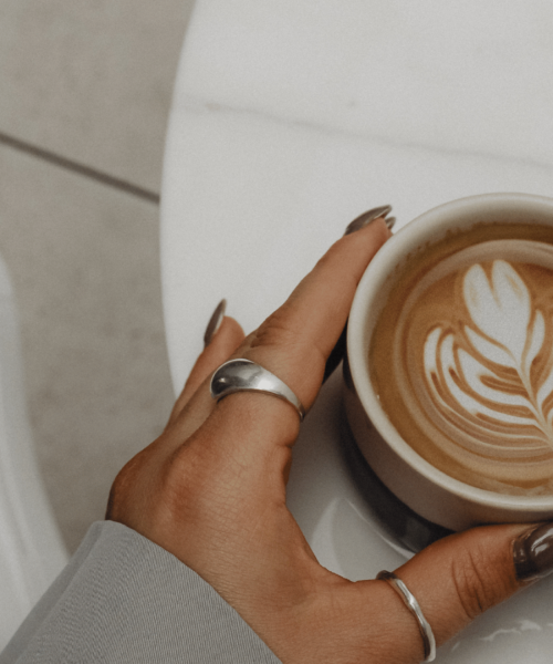 woman touching cup of coffee