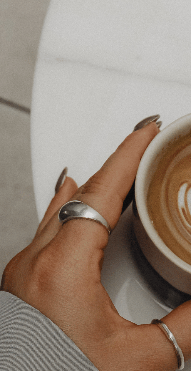 woman touching cup of coffee