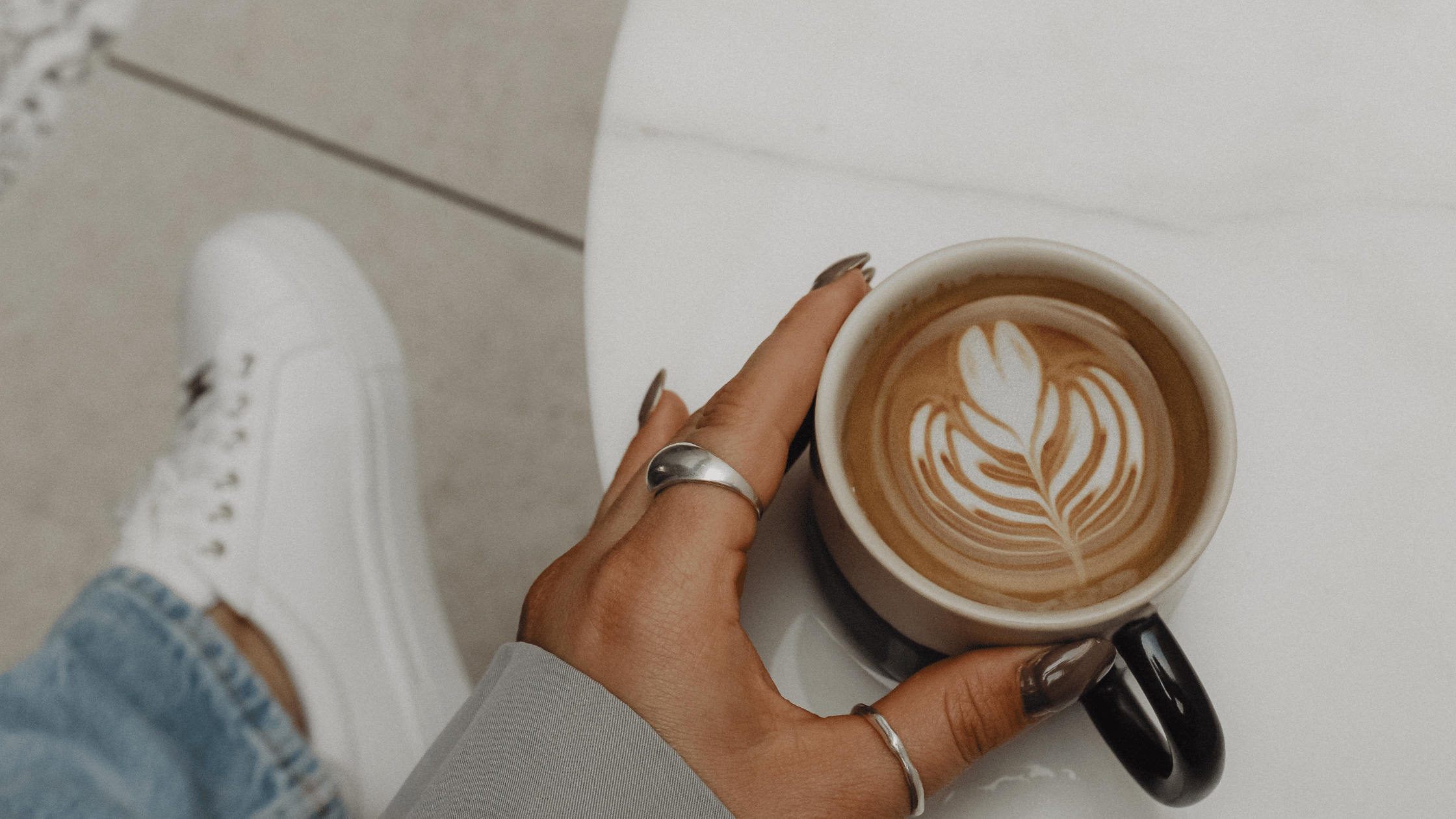 woman touching cup of coffee