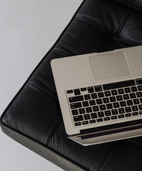 laptop sits on a black leather chair