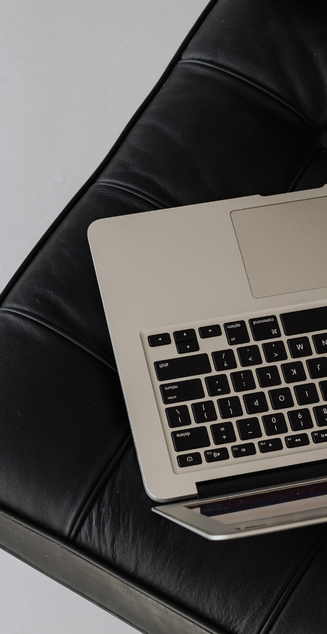 laptop sits on a black leather chair