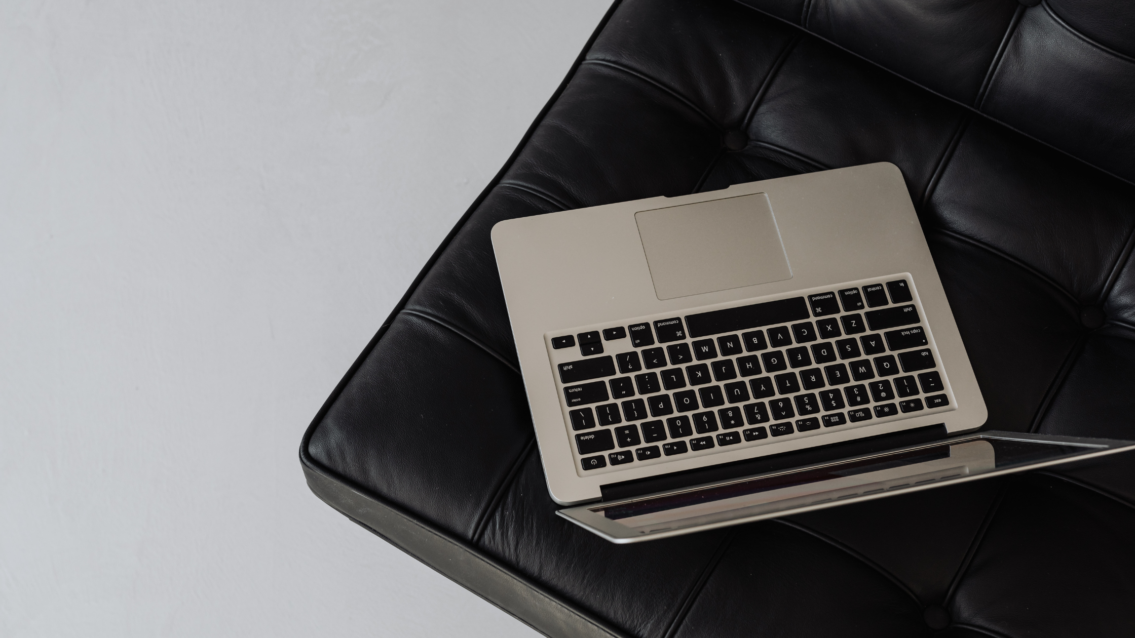 laptop sits on a black leather chair