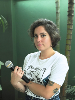 portrait of team member holding a microphone